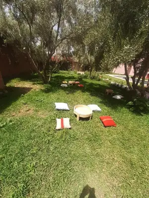 a table and chairs on the grass in a yard at House Medina Villa in Salene