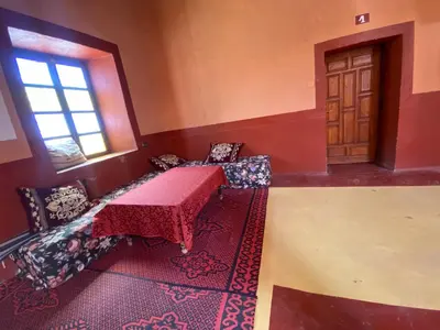 a room with a table and chairs and a window at Auberge camping ouadjou in Nkob