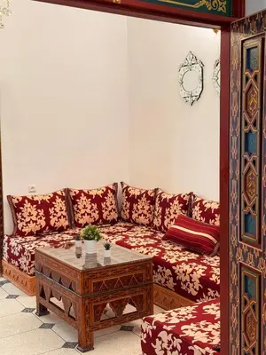 a living room with a couch and a coffee table at Dar Senhaji in Fès