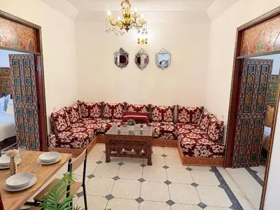 a living room with a couch and a table at Dar Senhaji in Fès