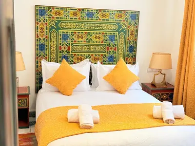 a bedroom with two beds with towels on them at Dar Senhaji in Fès