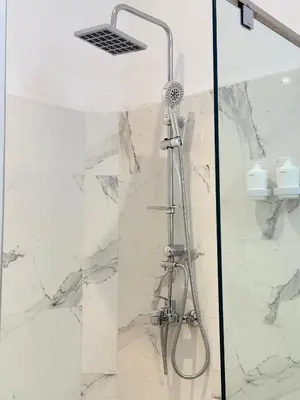 a shower in a bathroom with white marble at Dar Senhaji in Fès