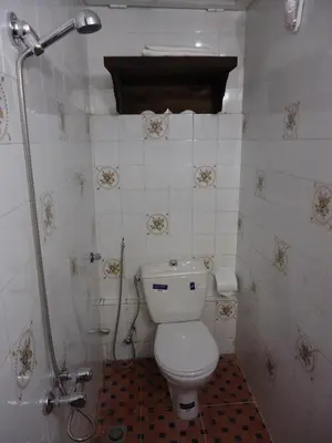 a small bathroom with a toilet and a shower at Dar Tadla Fes in Fès