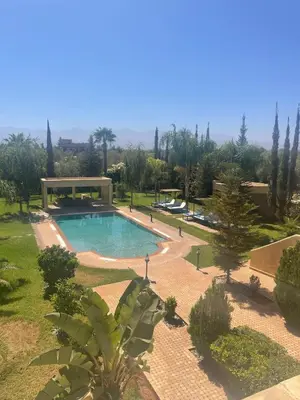 a swimming pool in a park with trees at Splendide Villa 5 chambres de luxe PRIVATISEE avec Cuisinière - Piscine chauffée - Jacuzzi & Hammam in Had Abdallah Rhiat