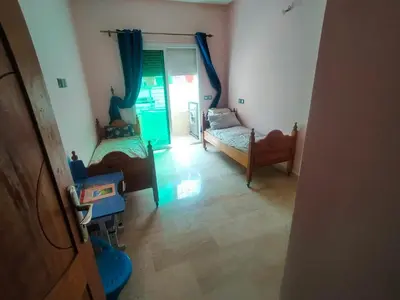 a living room with two beds and a window at Célia House in Fès