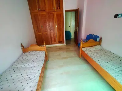 two beds sitting in a room with a hallway at Célia House in Fès