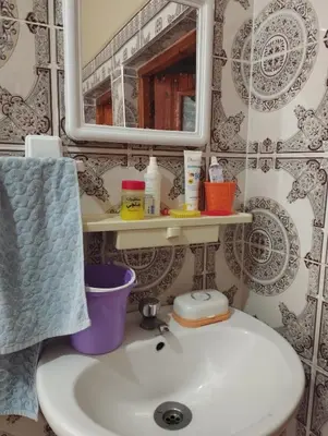 a bathroom with a sink and a mirror at Chez l'habitant Fatima in Arhbar