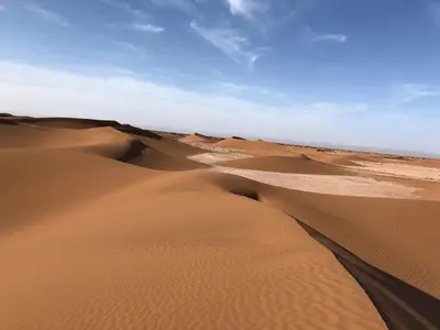 a group of sand dunes in the desert at Iriki Dreams in Bou Rbia