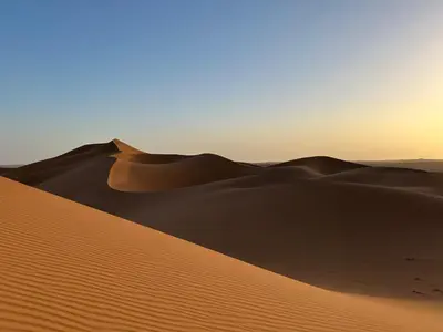 a sand dune in the desert at sunset at Iriki Dreams in Bou Rbia