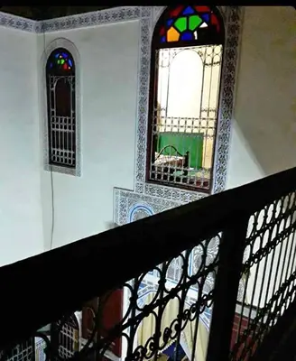 a room with two stained glass windows and a staircase at Riad Fès City in Fès