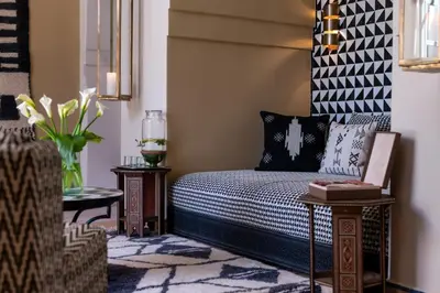 a bedroom with a bed and two end tables at Luxurious Villa with private pool - Kasbah Conti in Marrakech
