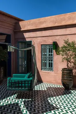 a pair of chairs on the porch of a house at Luxurious Villa with private pool - Kasbah Conti in Marrakech