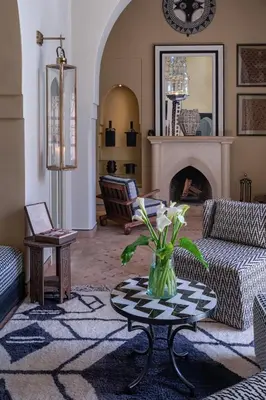 a living room with a vase of flowers on a table at Luxurious Villa with private pool - Kasbah Conti in Marrakech