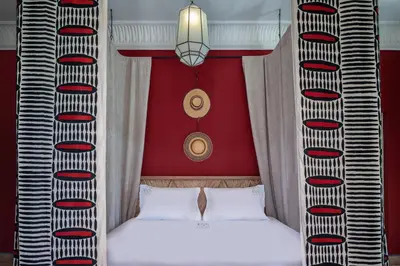 a bedroom with two beds and a red wall at Luxurious Villa with private pool - Kasbah Conti in Marrakech