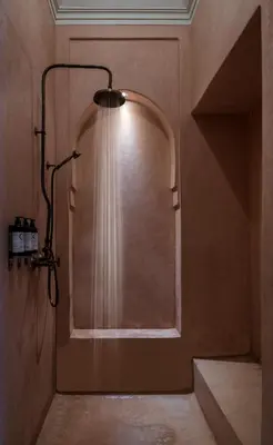 a bathroom with a shower with a light on the wall at Luxurious Villa with private pool - Kasbah Conti in Marrakech