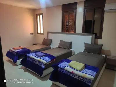 a room with three beds in a room at hotel DIJON ouzoud in Ouzoud