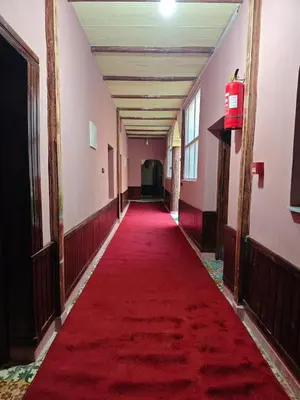 a long hallway with a red carpet in a building at Gite Ritch in Amellagou