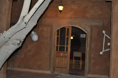 an entrance to a house with a door and a tree at Auberge Itrane merzouga in Merzane