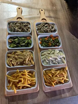 four plastic containers filled with different types of food at Appartement familial confortable au centre ville in El Kelaa des Srarhna