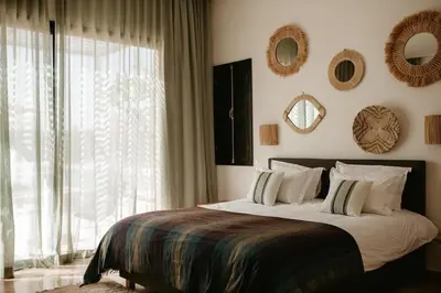 a bedroom with a large bed and a large window at Luxury 5-Suite Villa with Heated Pool, Steam Room & Games in Marrakech