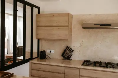 a kitchen with a counter top and a stove top oven at Luxury 5-Suite Villa with Heated Pool, Steam Room & Games in Marrakech