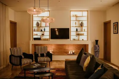 a living room with a couch and a tv at Luxury 5-Suite Villa with Heated Pool, Steam Room & Games in Marrakech
