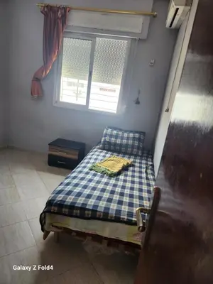 a small bedroom with a bed and a window at اناسي مرجان مكناس in Meknès