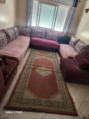 a couch in a living room with a rug at اناسي مرجان مكناس in Meknès