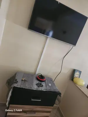 a room with a table with a tv on the wall at اناسي مرجان مكناس in Meknès