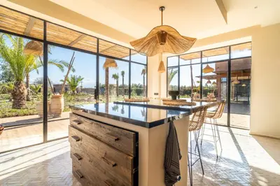 a kitchen with large windows and a large island at VILLA 2s in Marrakech