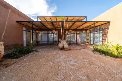 a large building with a pavilion with glass windows at VILLA 2s in Marrakech