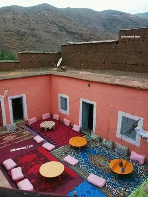 a building with tables and chairs on a patio at Hôtel flora in Beni Mellal