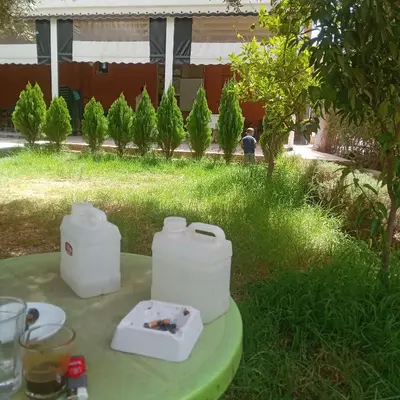 a table with two white containers on top of it at Hôtel flora in Beni Mellal