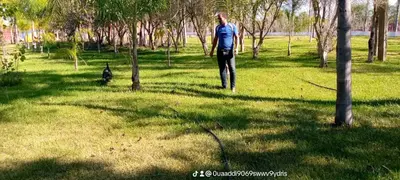 a man walking in a field with a dog at Hôtel flora in Beni Mellal