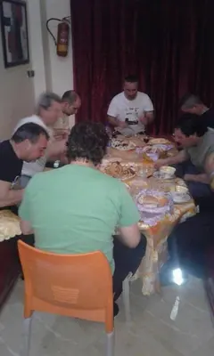a group of people sitting around a table eating at Maison d'hôtes de Zaida in Zaida