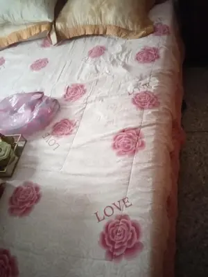 a bed with pink roses and the words love on it at Chez l habitant mayorka in Sefrou