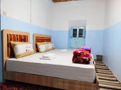 a bedroom with a large bed in a room at Tagmat guest house in Toufrine