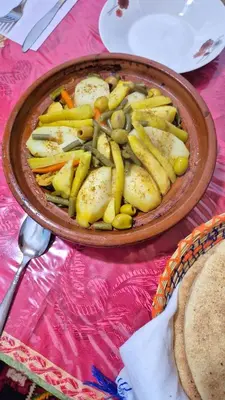 a bowl of food with vegetables on a table at Tagmat guest house in Toufrine