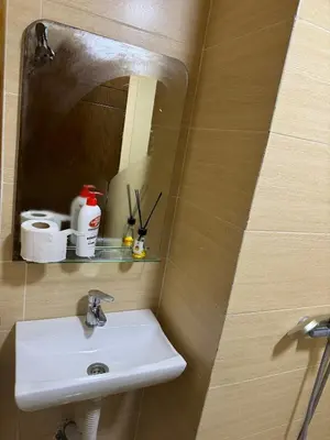 a bathroom with a sink and a mirror at Maison avec ascenseur in Fès