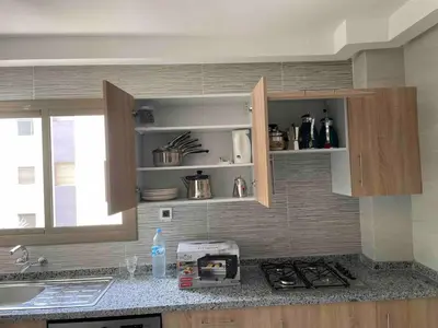 a kitchen with a sink and a counter top at Maison avec ascenseur in Fès