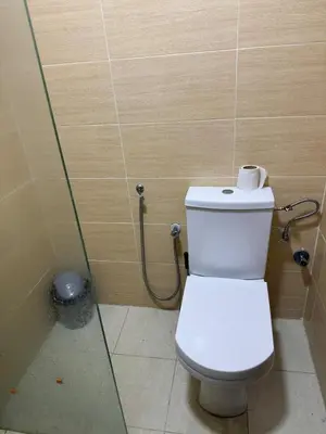 a bathroom with a toilet and a shower at Maison avec ascenseur in Fès