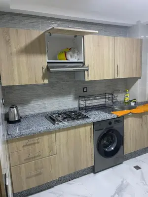 a kitchen with a stove and a washing machine at Chic and comfortable air-conditioned apartment in Fès