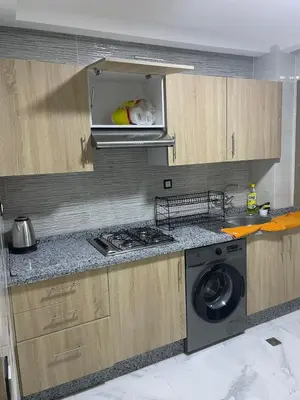 a kitchen with a stove and a washing machine at Chic and comfortable air-conditioned apartment in Fès