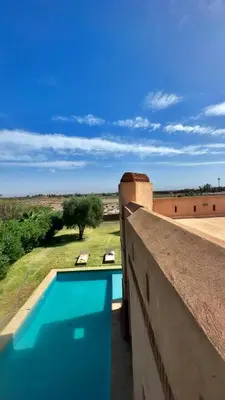 a view of a swimming pool from the balcony of a house at Beautiful Villa near Marrakesh in Marrakech