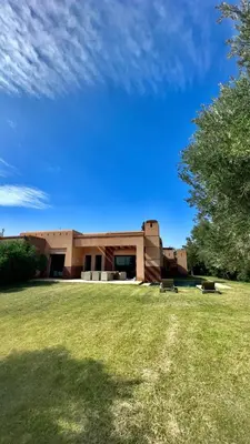a building with a grass field in front of it at Beautiful Villa near Marrakesh in Marrakech