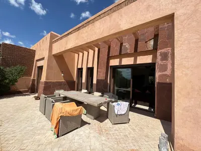 a patio with a table and chairs outside of a building at Beautiful Villa near Marrakesh in Marrakech