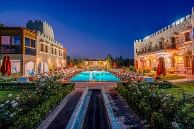 a hotel with a swimming pool at night at Atlas Castle Marrakech in Marrakech