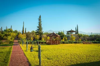 a park with a playground and a gazebo at Atlas Castle Marrakech in Marrakech