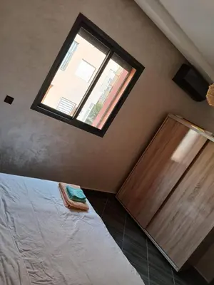 a bedroom with a bed and a window in a room at Appartement a marrakech in Oulad Akkou