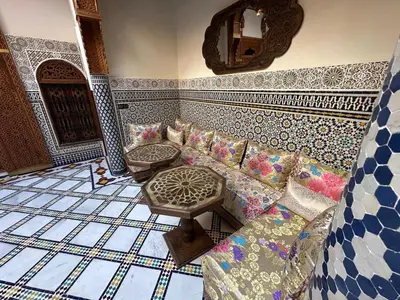a living room with a couch and a table at Riad Joseph in Fès